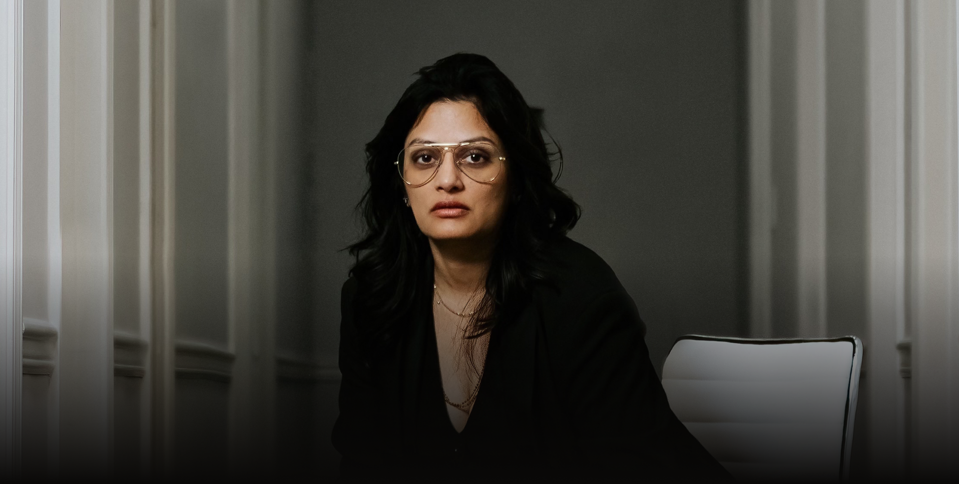 Dr. V at her desk — physician-led precision wellness