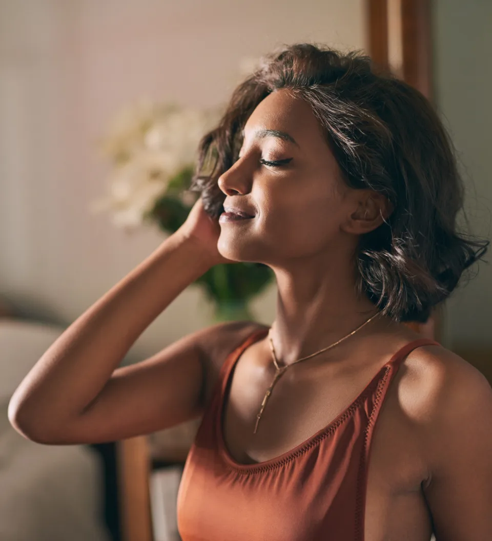 Woman practicing yoga on balcony overlooking Gulf of Mexico at sunrise